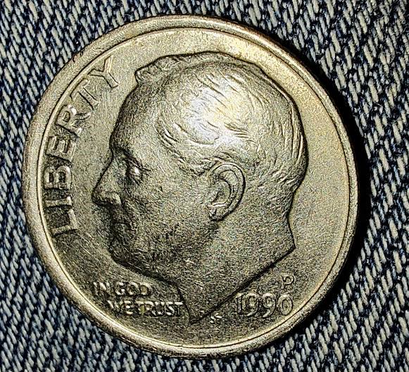1990 dime off-center strike error showing shifted design and blank planchet area